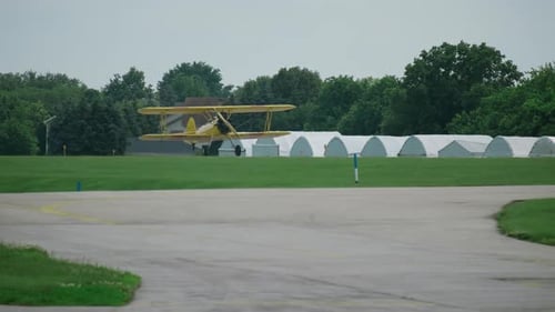 A Propeller Plane Landing on the Runway at a Small Airport Slow Motion View