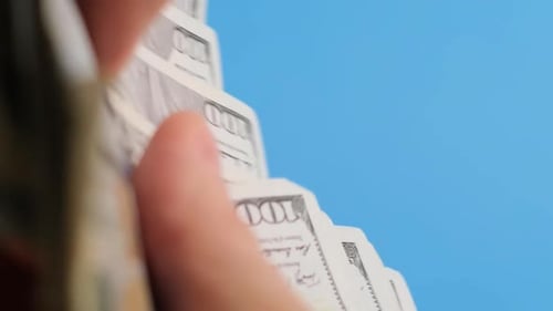 Counting Stack of One Hundred Dollar Bills
