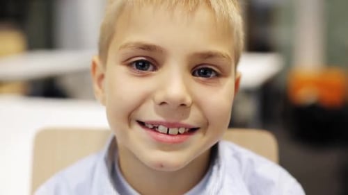 Smiling Boy Poses for Camera Indoors