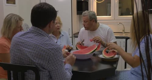 Family and Friends Enjoy Watermelon at Home