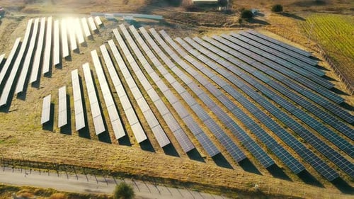 Aerial View of Solar Panels in Rural Field