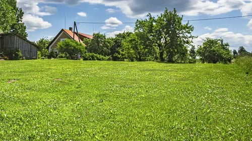 Mowing the lawn at a countryside cottage - timelapse