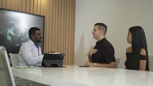 Doctor Listens to Patient's Heart in Modern Office