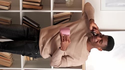 Smiling Man Talking on Phone at Home