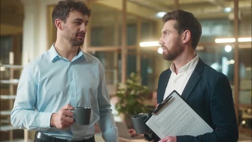 Two Professional Businessmen Colleagues Business Partners Coworkers Drink Coffee Together at Office