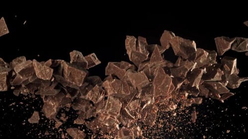 Chocolate Chunks Floating and Scattering on Black Background