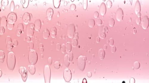 Abstract Bubbles Moving in Pink Liquid
