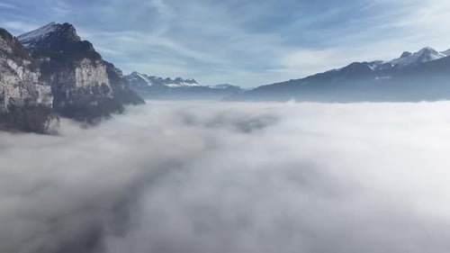 Misty Walensee Amid Churfirsten Peaks. Switzerland aerial over fog