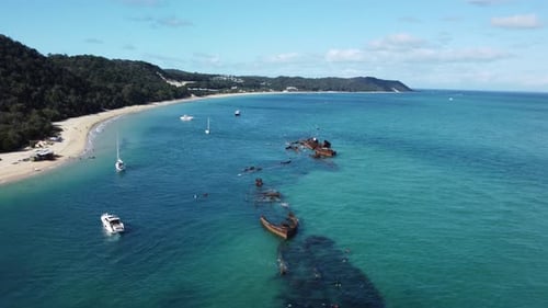 Beautiful coastline of turquoise sea water, white sand, trees and shipwrecks