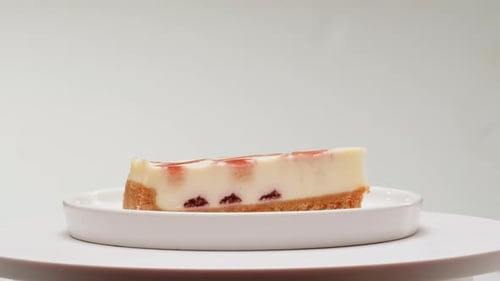 Strawberry Cheesecake Slice on White Plate