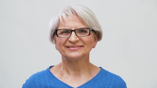 Vision and Old People Concept - Portrait of Smiling Senior Woman Adjusting