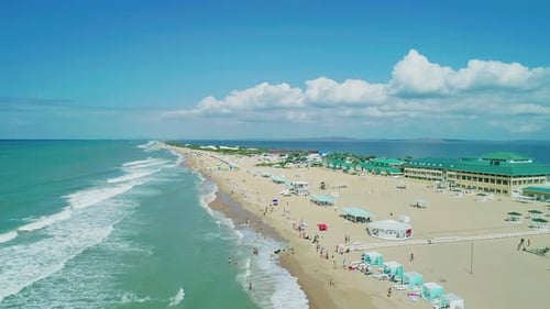Aerial Over the Long Sandy Spit with a Beach and Azure Water on a Sunny Summer Day Waves Crashing to