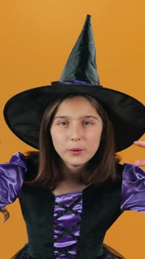 Child Dressed as Witch in Costume Gesturing