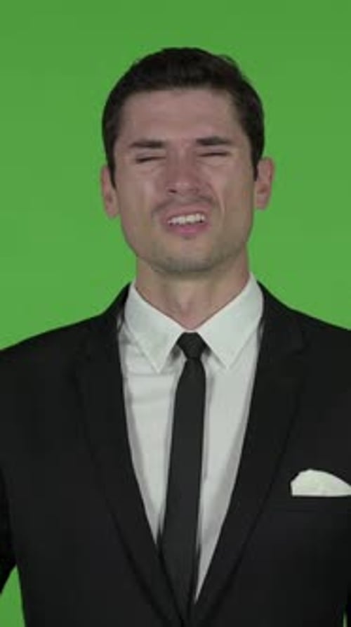 Young Businessman having Headache, Chroma key, vertical video