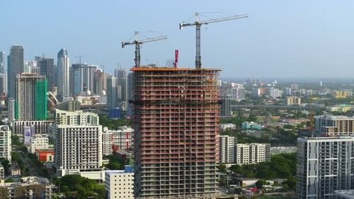 Tower Lifting Cranes at High Residential Apartment Building Construction Site Real Estate