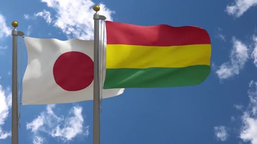 Realistic Waving Flags of Japan and Bolivia Against Blue Sky