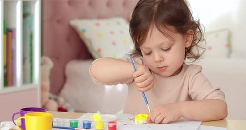 Cute Child Painting a Craft at Home
