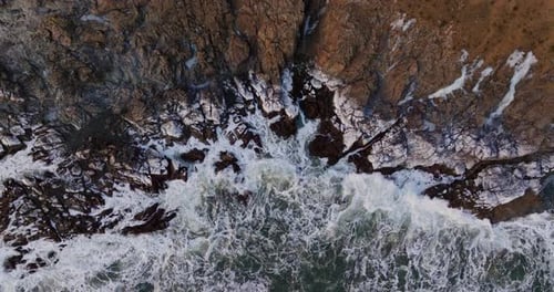 Aerial View Of Crashing Waves On Rocks