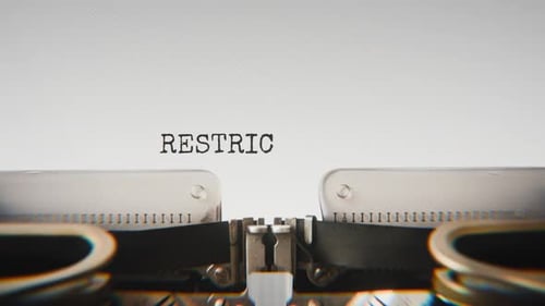 Old mechanical typewriter typing Restricted Archive in a close-up view.