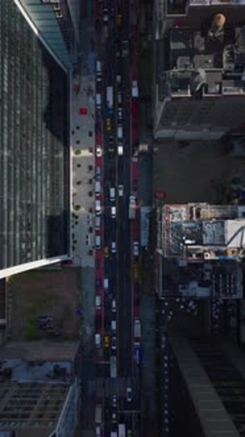Vertical View Capturing a Bustling Manhattan Street Filled with Traffic in Slow Motion Framed By