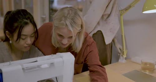 Fashion Students using Sewing Machine in Studio