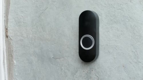 Finger Presses a Modern Doorbell Button
