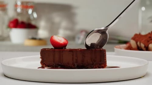 Chocolate Cake with Strawberry being Cut