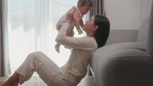 Woman Plays with Her Baby at Home