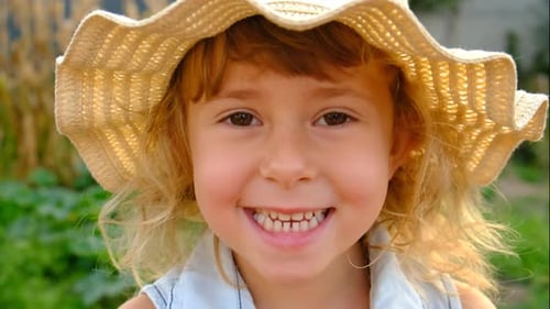 A Child in a Hat in a Garden Selective Focus