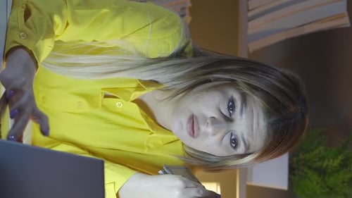 Woman Counts Cash at Desk at Night