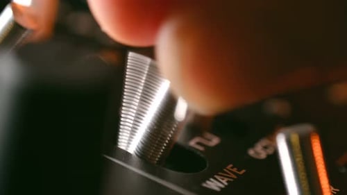 Producer Turns on Wave Lever on Console in Recording Studio