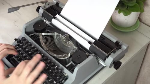 Writing a book and typing old typewriter, top view. Man typing on old vintage retro typewriter