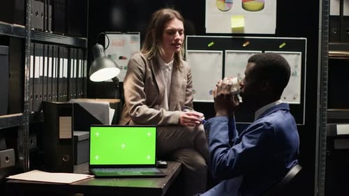 Detectives Talking in Office with Laptop
