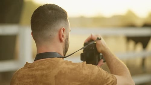 Man Taking Photos Outdoors During Golden Hour