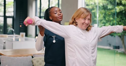 Mature Woman Exercising with Weights and Helper