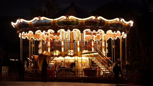 Carousel Spins Brightly at Night in Urban Setting