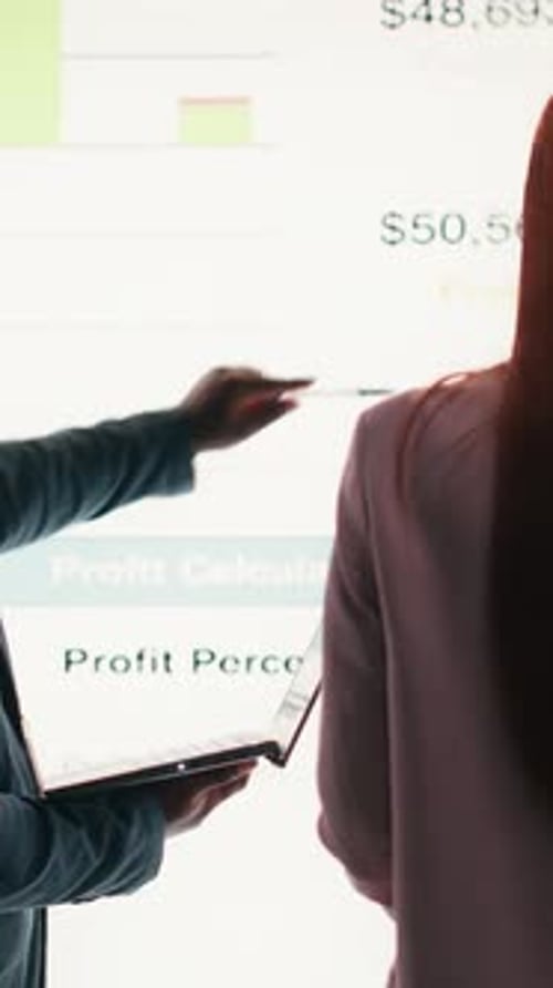 Vertical Video Analyzing Economic Data Graphs Laptop and Businesspeople
