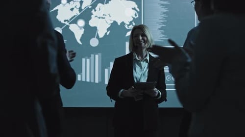 Business Presentation and Applause in Dark Office