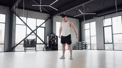 Fitness Enthusiast Performing Warm Up in Spacious Gym Room