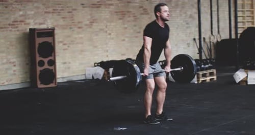 Fit Man Doing Squat In Gym Using Heavy Weights Looking Concentrated