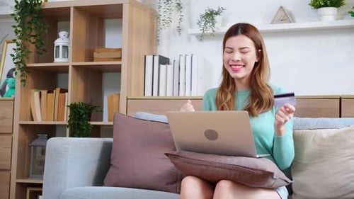 Woman Shopping Online with Credit Card at Home