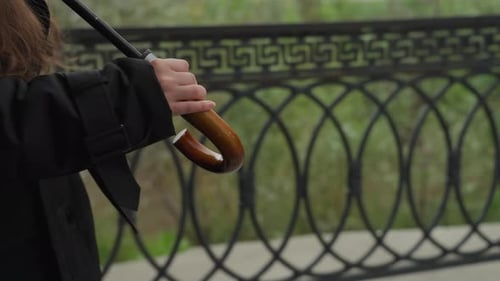 Personal Perspective Showing Hand Grasping Umbrella in Park Setting Intimate Scene Capturing Hand