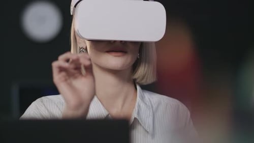 Woman with VR Headset Interacting with Virtual Reality