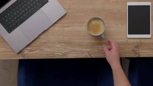 Top Down View of Coffee Mug Take From Table Next to Laptop and Tablet Working Days in Office or