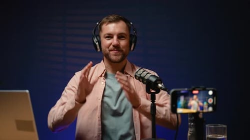 Man Recording Podcast with Microphone and Headphones