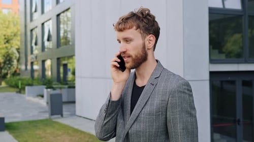 Young Adult Talking on Mobile Phone Outside Office