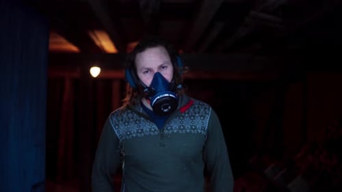 A Man Is Wearing A Single Gas Mask Chemical Industrial Respirator. Medium Close-up Shot
