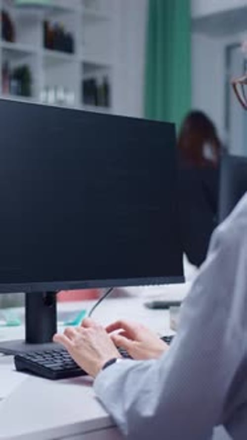 Woman Working on Computer in Office