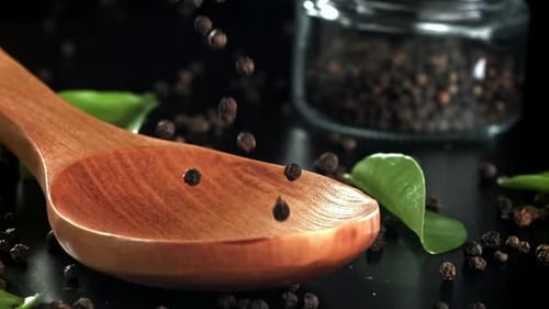 Black Pepper Falls on a Wooden Spoon Filmed on a Highspeed Camera at 1000 Fps