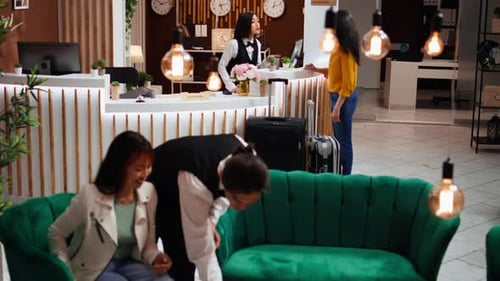 Asian Guest Asking Employee About Hotel Services and Facilities